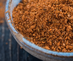 black background, blue bowl, filled with bbq rub